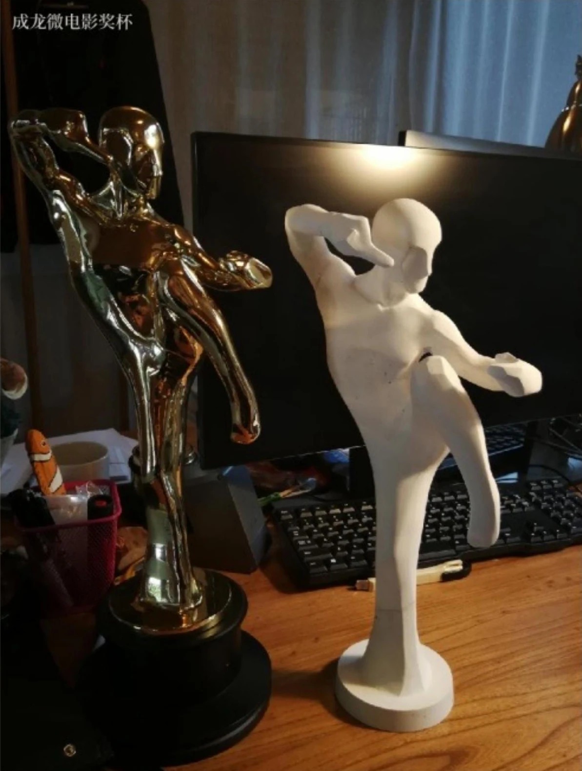 Figure and model of the Jackie Chan Microfilm Trophy