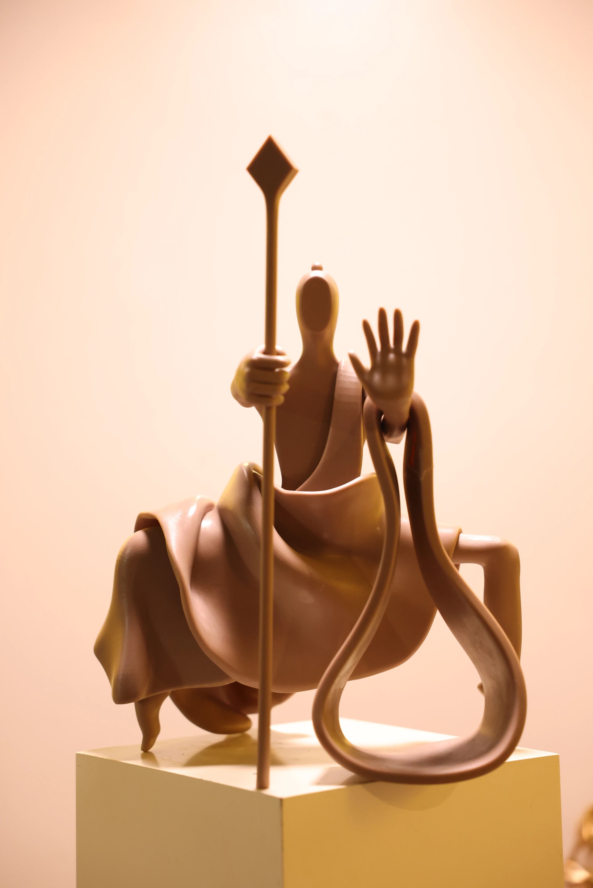 Close view of a staff-bearing figure mounted on an animal
